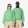 Unisex-sweatshirt med løs passform, badge-detaljer og halv glidelås