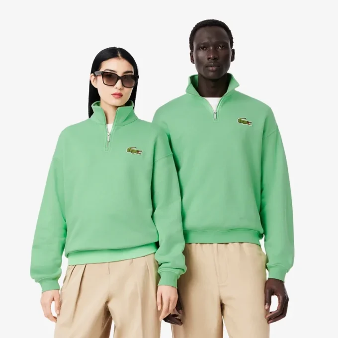 Unisex-sweatshirt med løs passform, badge-detaljer og halv glidelås