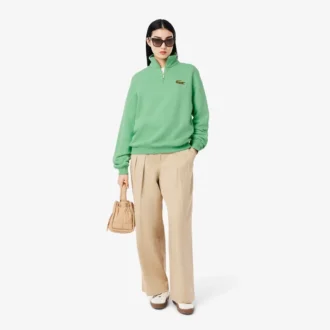 Unisex-sweatshirt med løs passform, badge-detaljer og halv glidelås