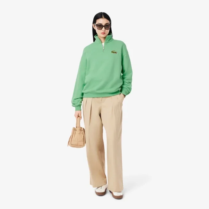 Unisex-sweatshirt med løs passform, badge-detaljer og halv glidelås