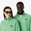 Unisex-sweatshirt med løs passform, badge-detaljer og halv glidelås