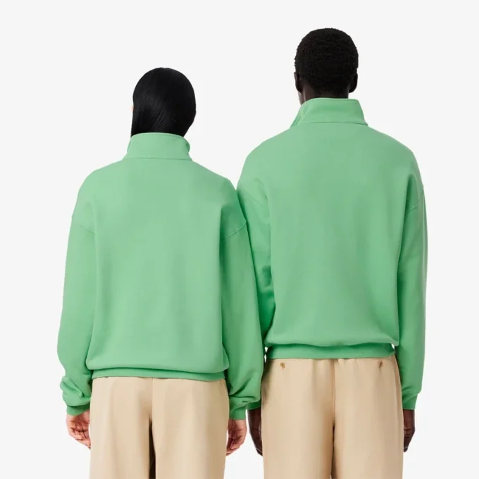 Unisex-sweatshirt med løs passform, badge-detaljer og halv glidelås